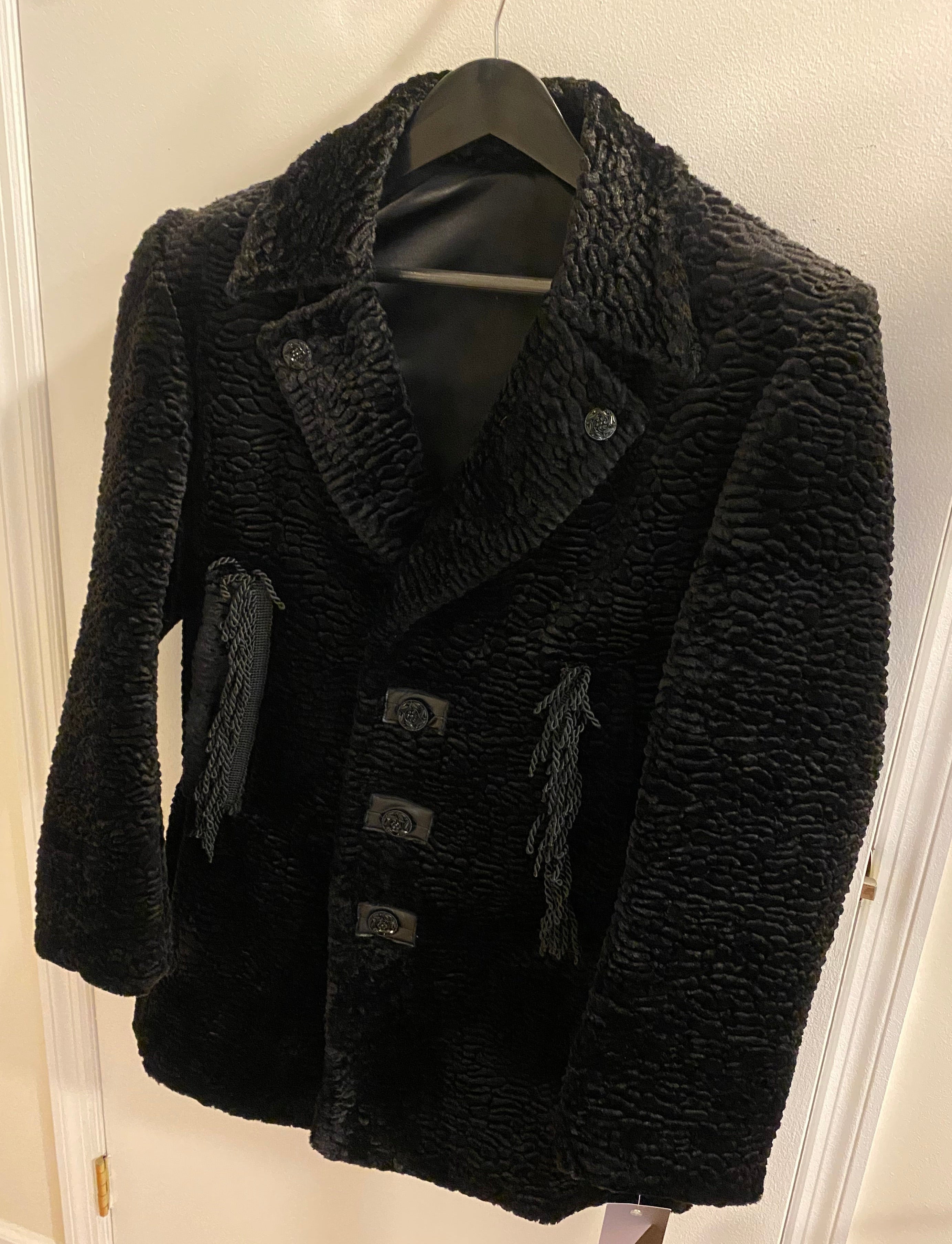 Black faux Persian lamb jacket by Stacy  Couture shown without snap in fur trimmed hood.